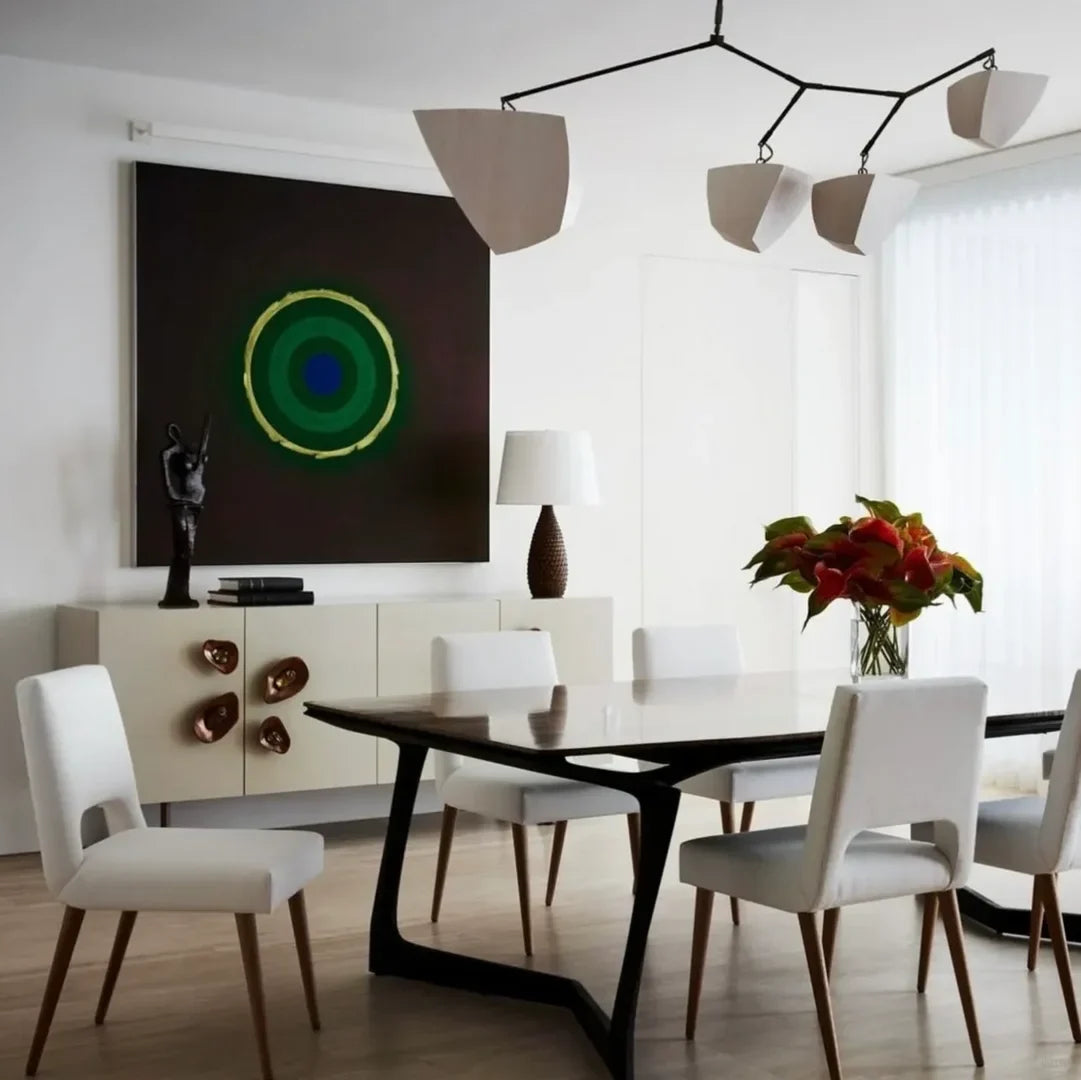 Brass branching chandelier with frosted white shades over dining table