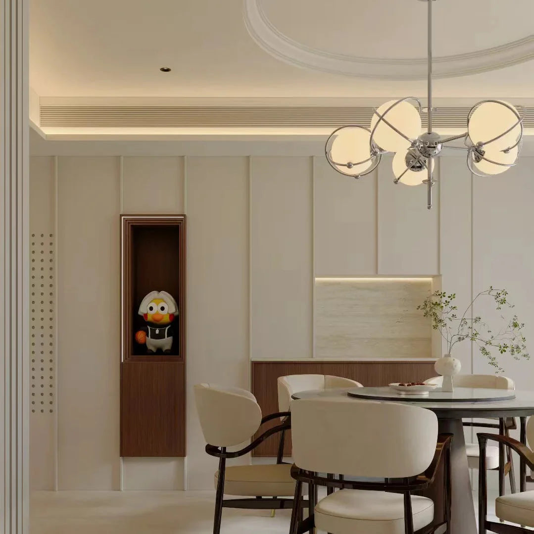 Orbit-style chandelier over dining area with round opal glass shades and chrome arms