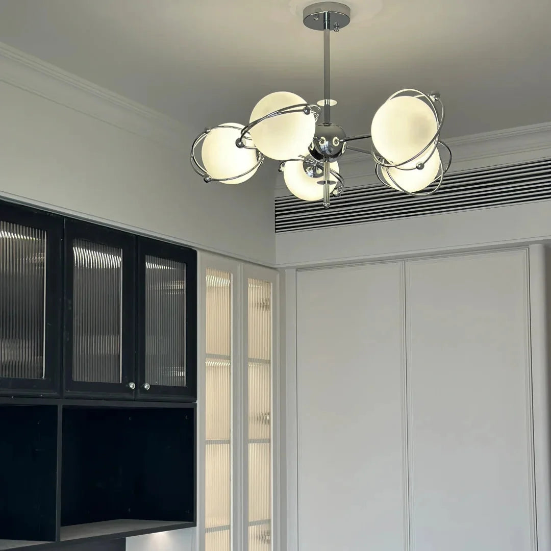 Orbit-style ceiling chandelier with multiple round opal glass shades and chrome frame