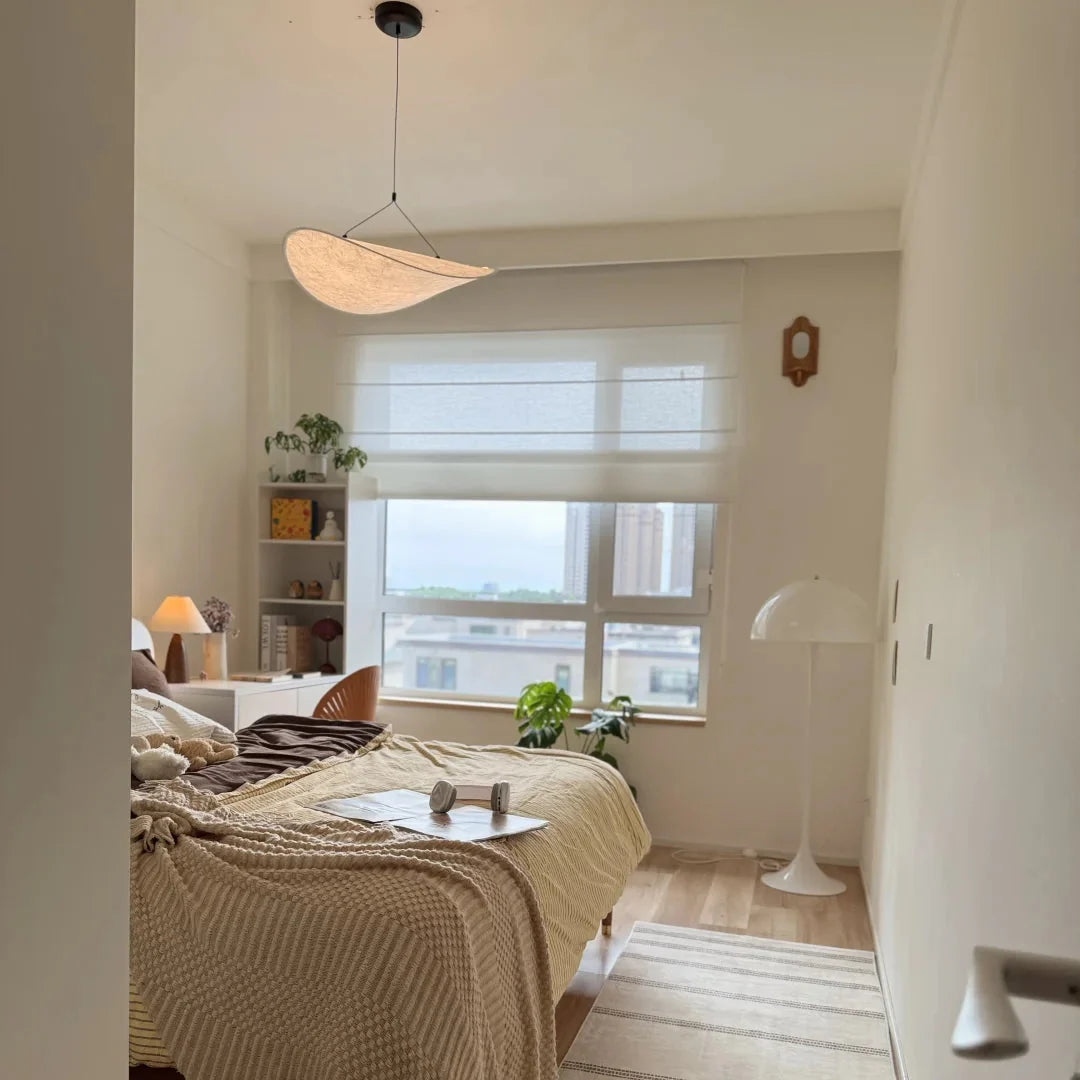Wood-toned paper pendant light with oval shade and hanging cord.