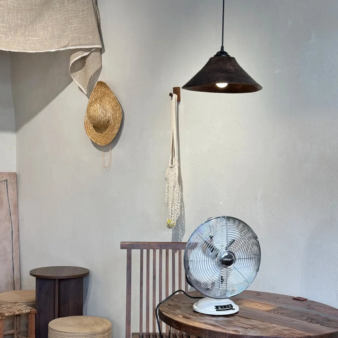 Cone wood pendant light with dark wood shade and warm bulb, hanging in a room