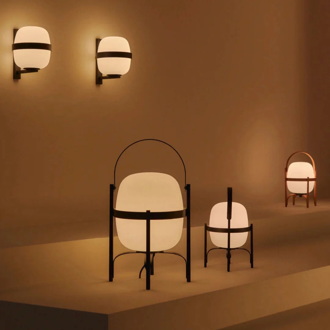 Wall-lit table lamps with frosted globe shades and black frames, curved handles
