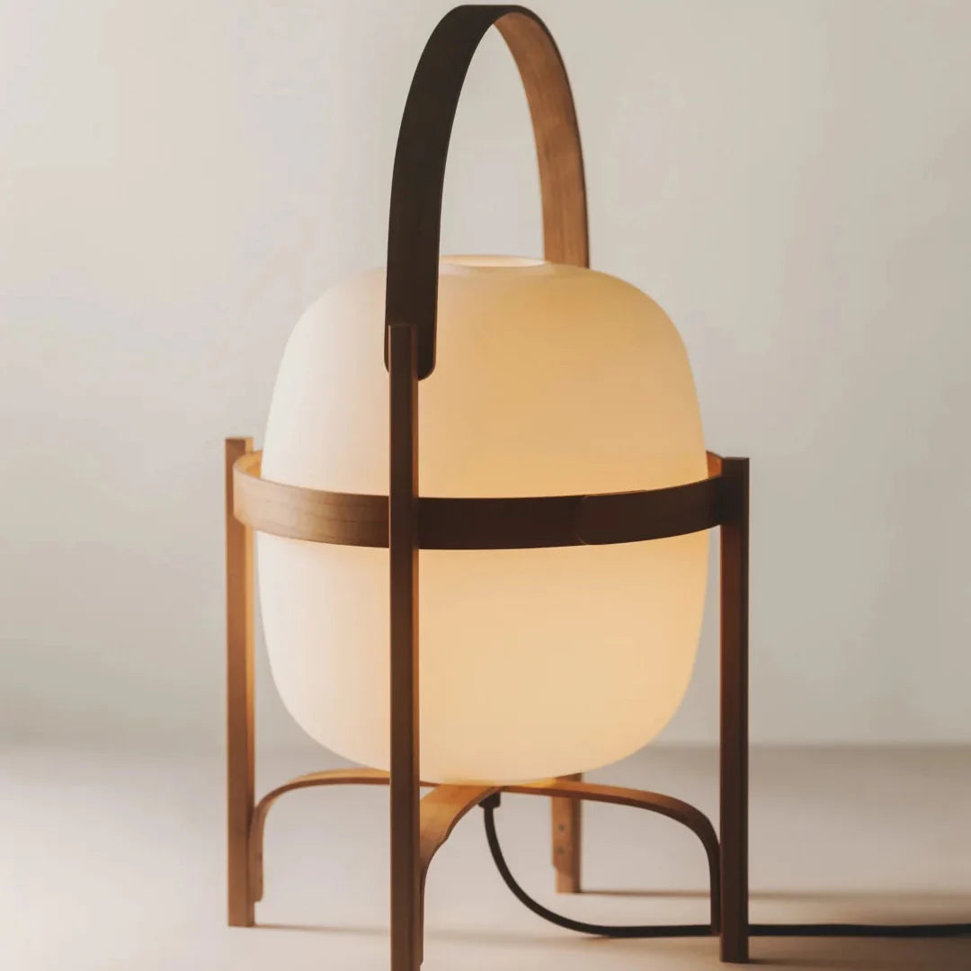 Table lamp with frosted glass globe shades and dark wood frame with arched handle