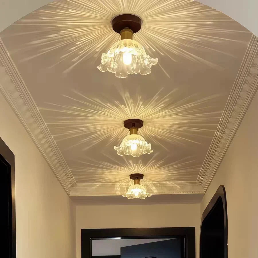 Semi-flush ceiling light with clear petal glass shade and warm amber bulb