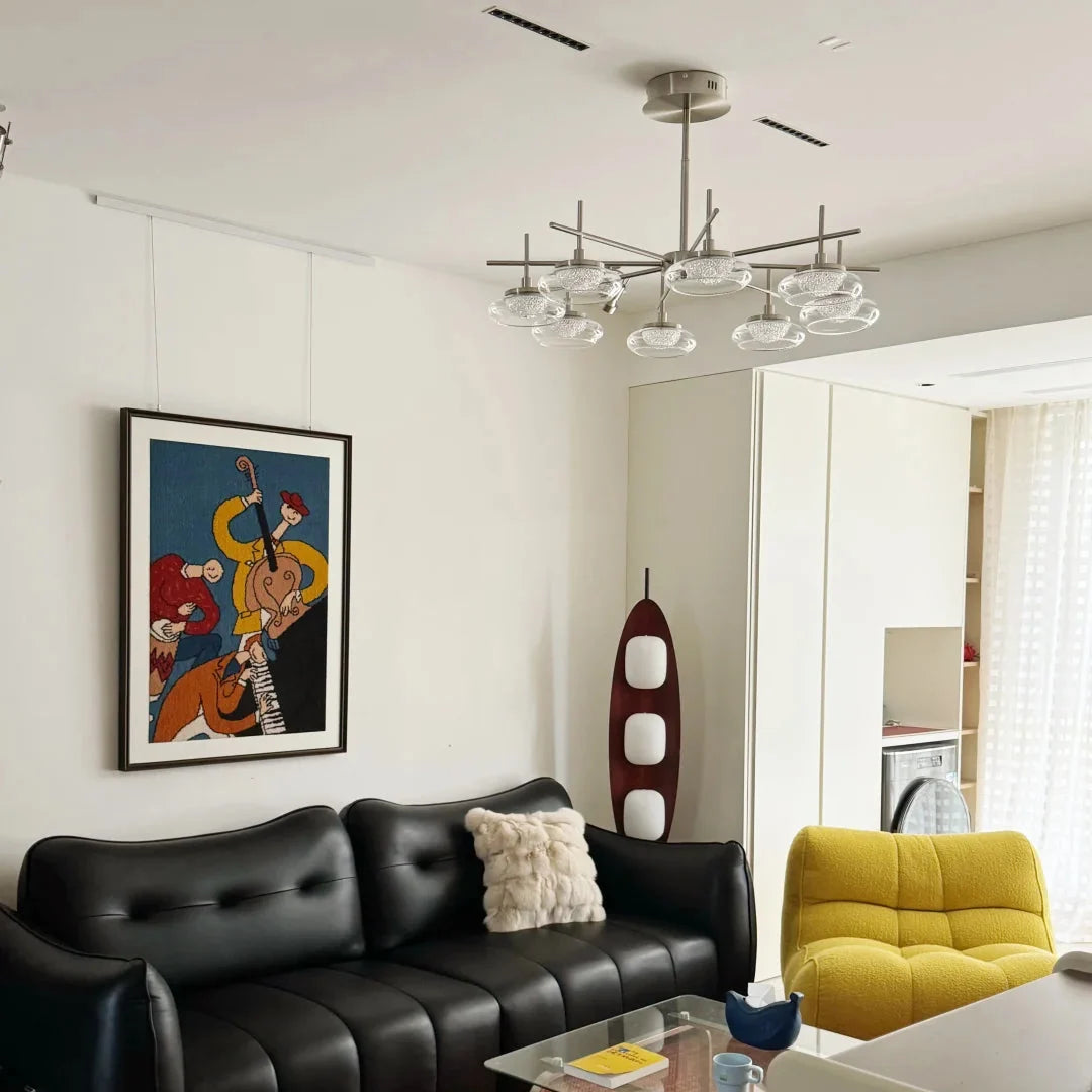 Minimal spider chandelier with brushed metal stem and clear glass bowl shades.