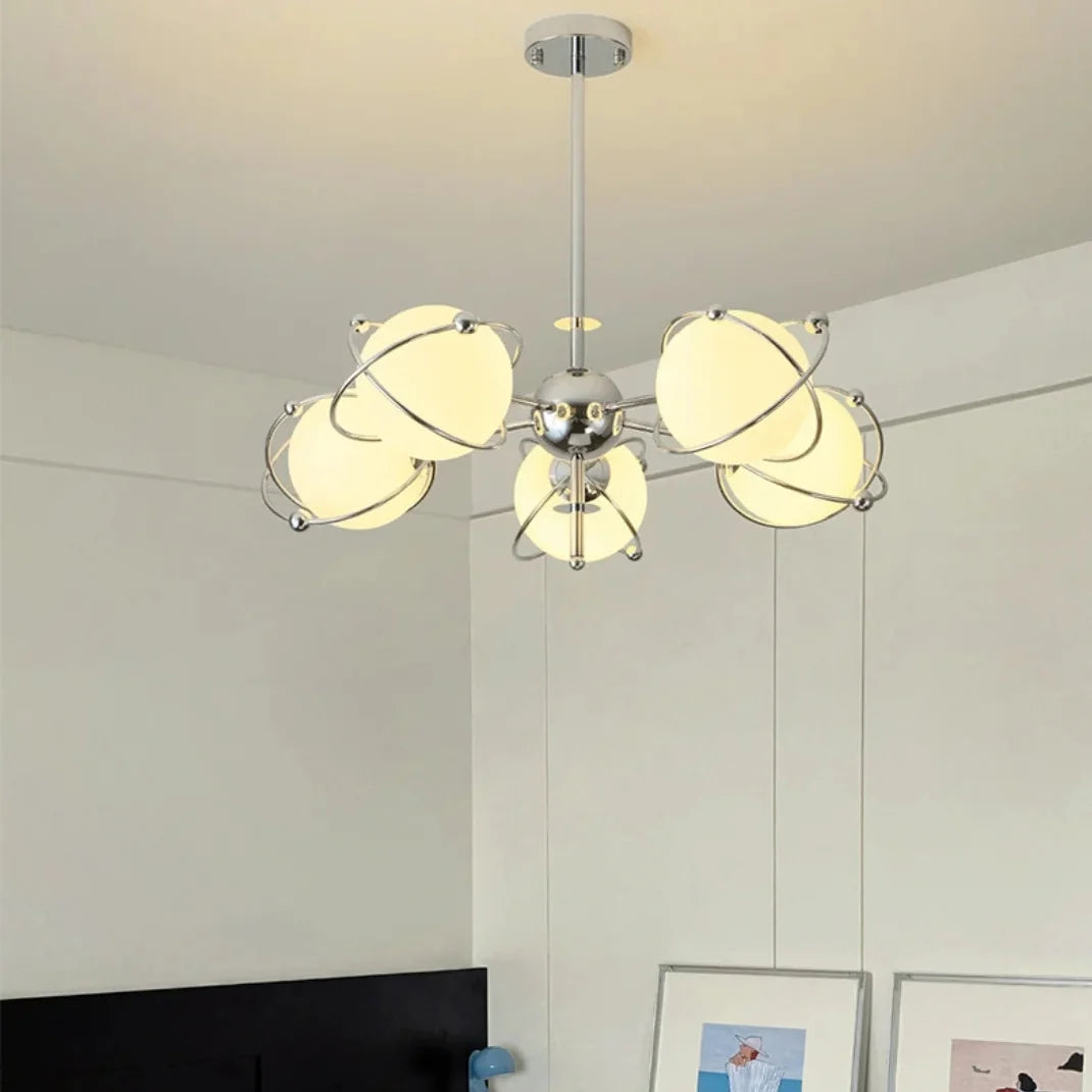 Orbit-style chandelier with chrome hub and four-plus round opal glass shades