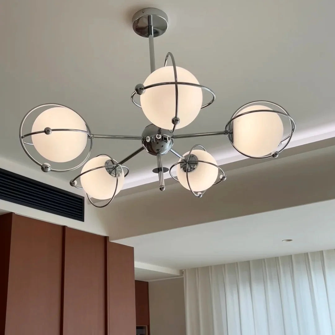 Multi-light orbit chandelier with chrome arms and frosted round glass shades