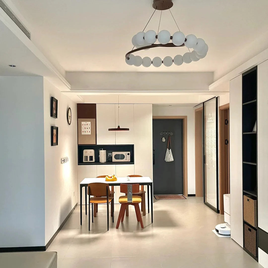 Modern pearl spiral chandelier with white round globe shades and metal ring canopy