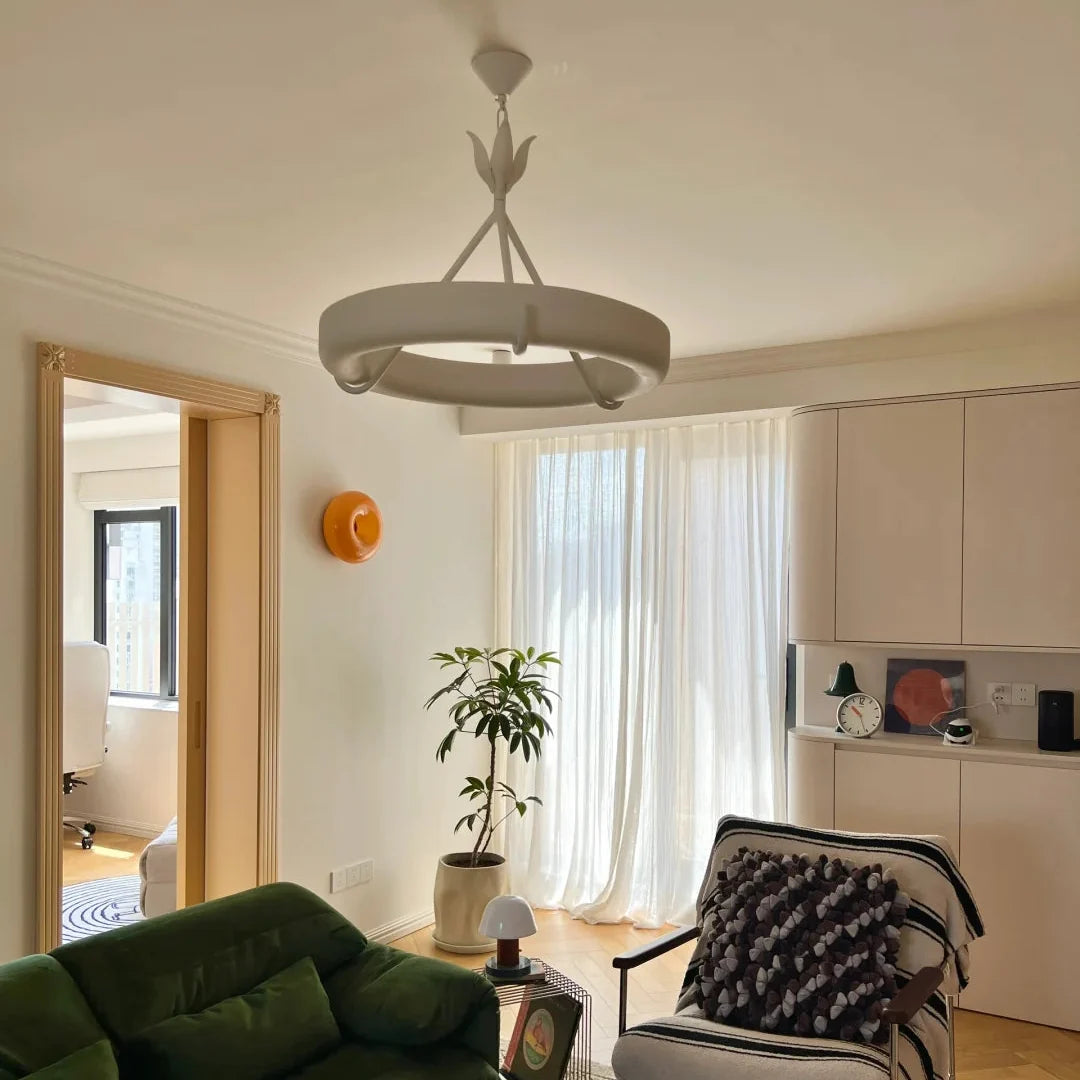 White circular ceiling chandelier with three-prong stem and curved ring light base