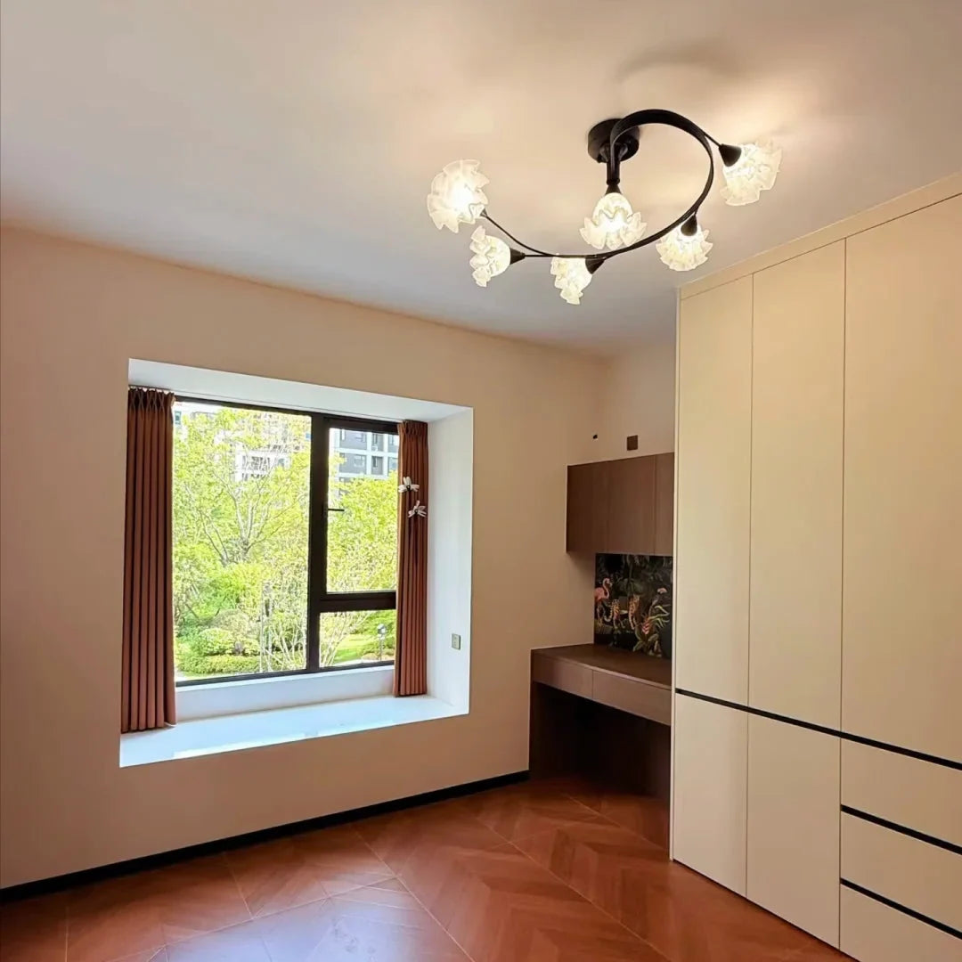 Black floral-branch semi-flush chandelier with curving arms and glass globe shades