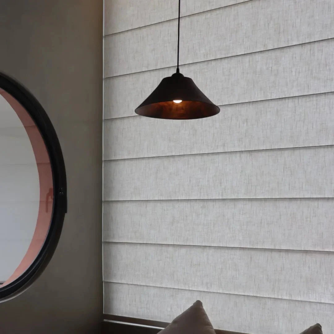 Cone wood pendant light with dark wood shade and warm bulb, suspended from cord
