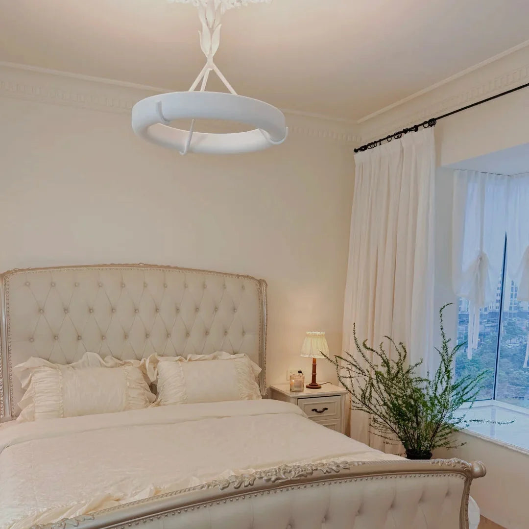 White ceiling chandelier with wide circular diffuser and slender branching stem