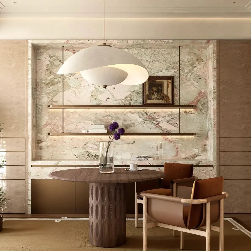 Gray aluminum wave pendant light with warm glow over modern room
