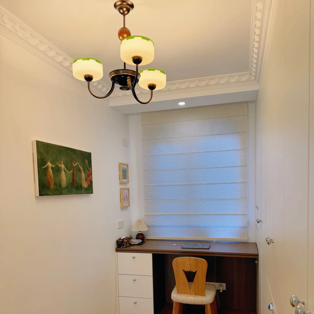 Bronze multi-arm chandelier with three opal glass shades and decorative curved arms