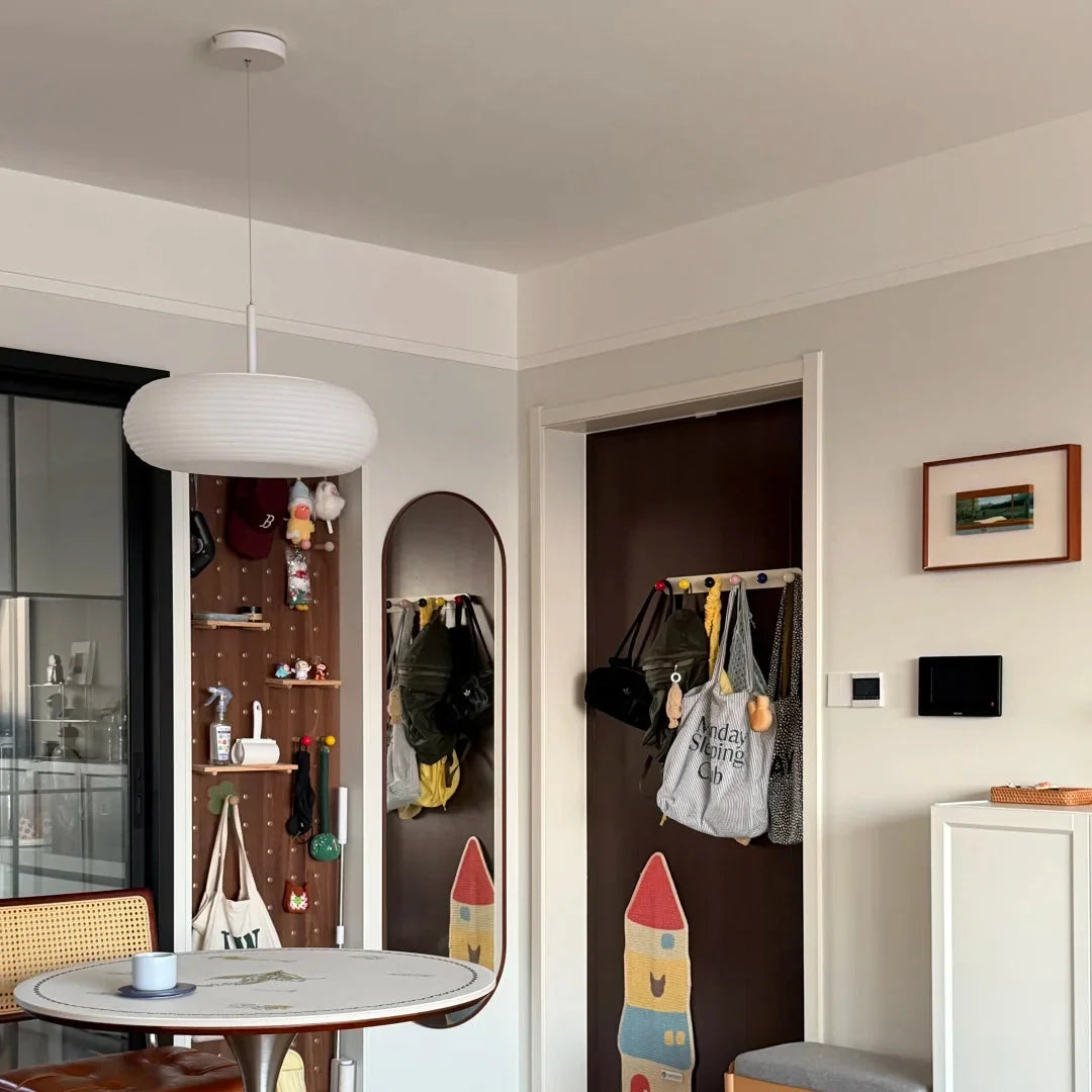 Luma Pebble pendant with ribbed white drum shade hanging from a white cord
