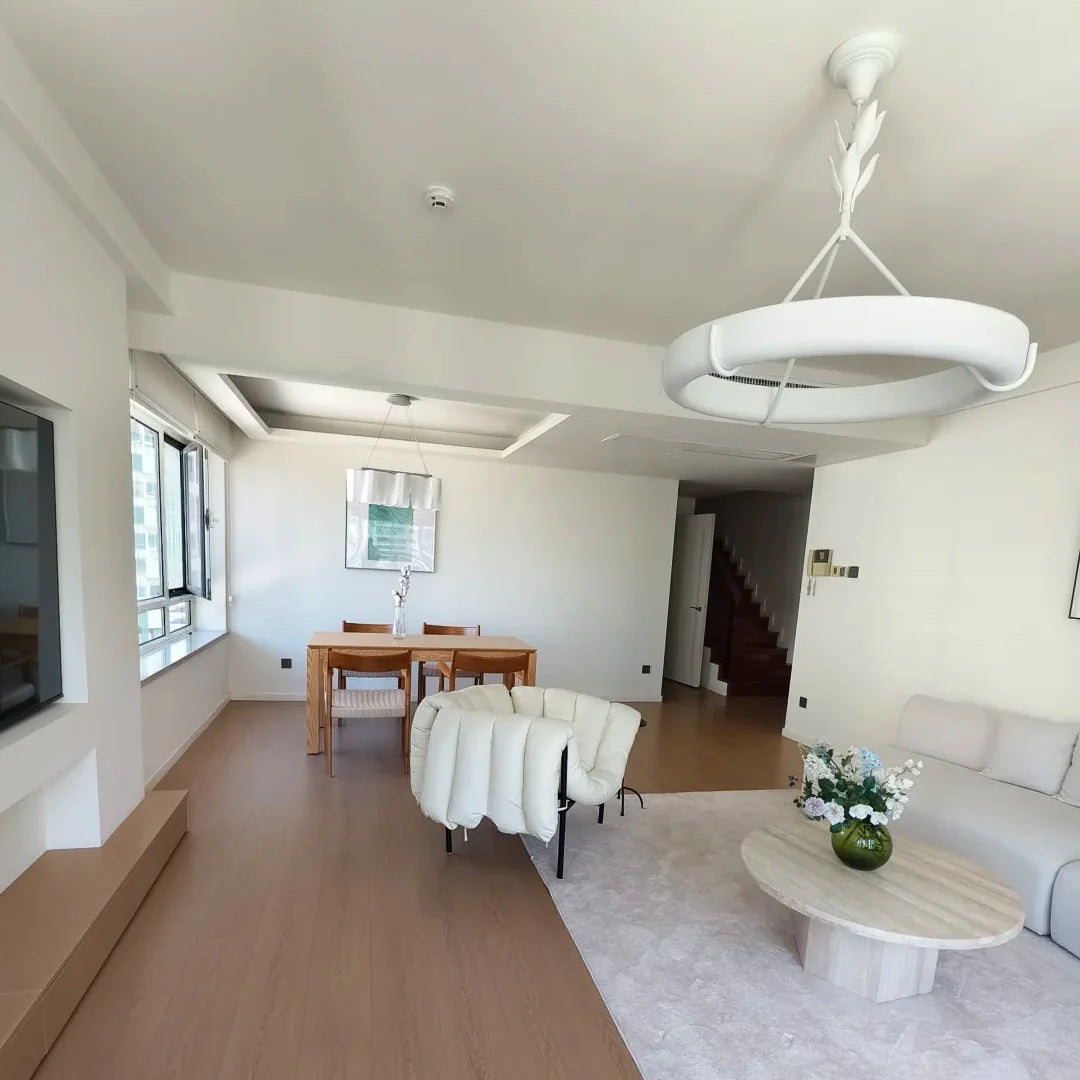 White circular ceiling chandelier with curved arms and central stem