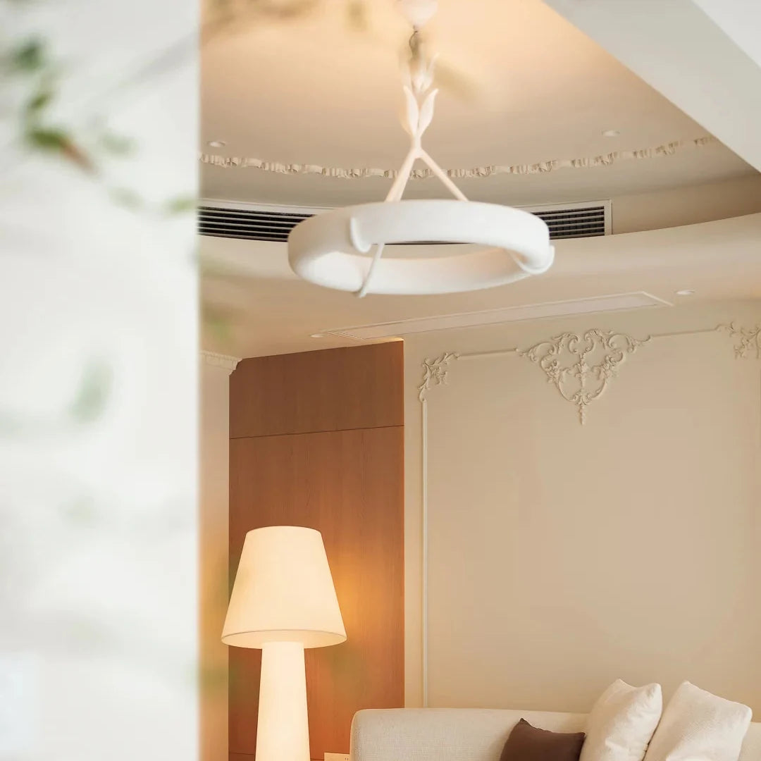 White leaf-stem chandelier with circular shade and a curved metal band frame
