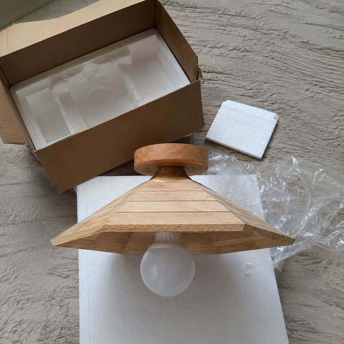 Wood flush-mount ceiling light with layered cone shade and frosted bulb diffuser, in box