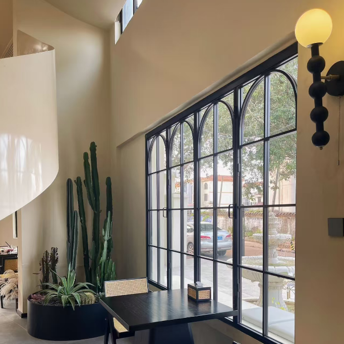 Matte black beaded globe wall lamp with white globe shade and brass connector