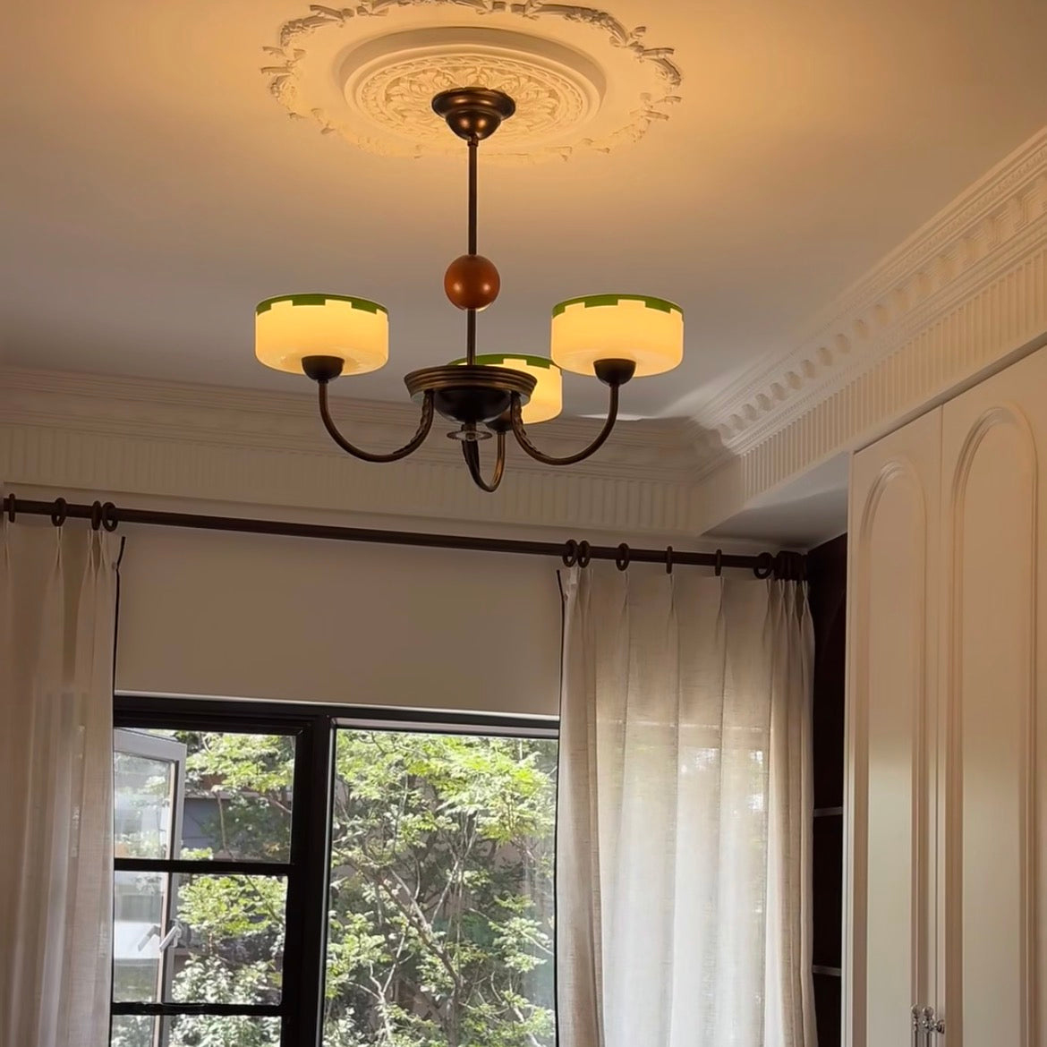 Bronze multi-arm chandelier with cream opal glass shades and amber bead accents