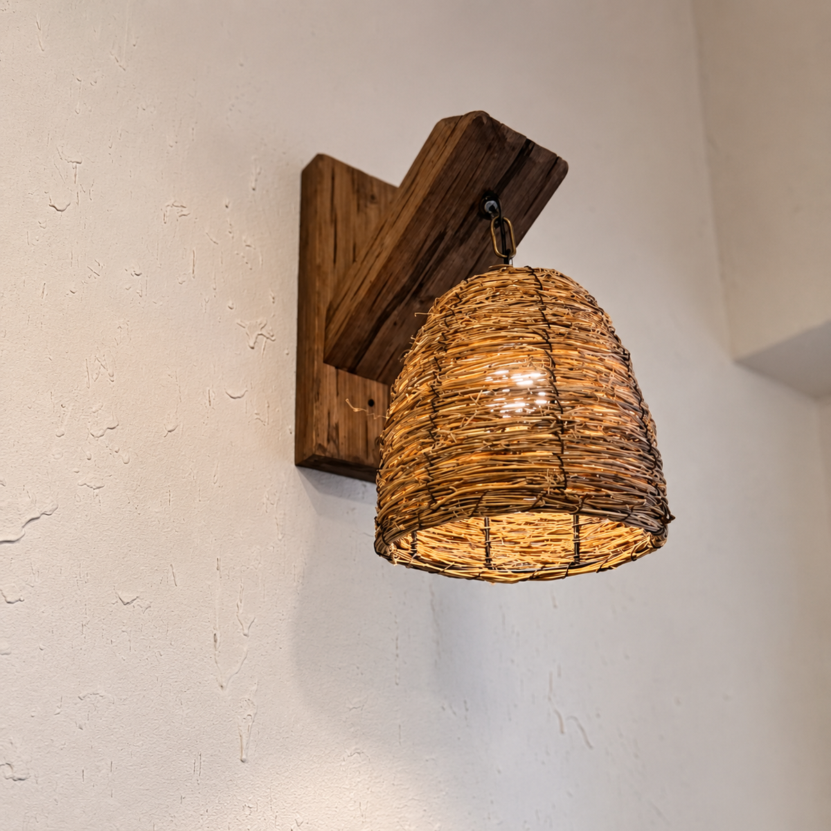 Wood wall-mounted lantern with woven rattan shade and metal chain, warm light glow