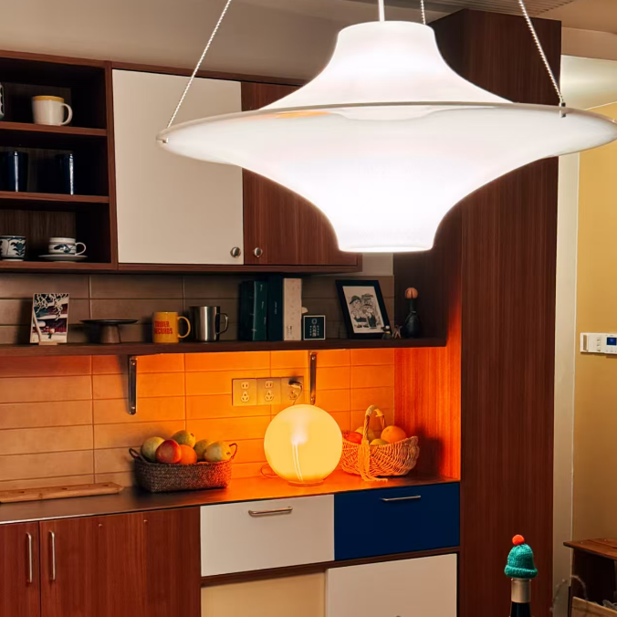 White disc pendant light with hanging cord suspension