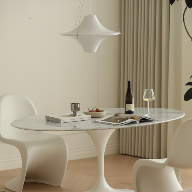 White disc pendant light with star-shaped shade hanging by cord