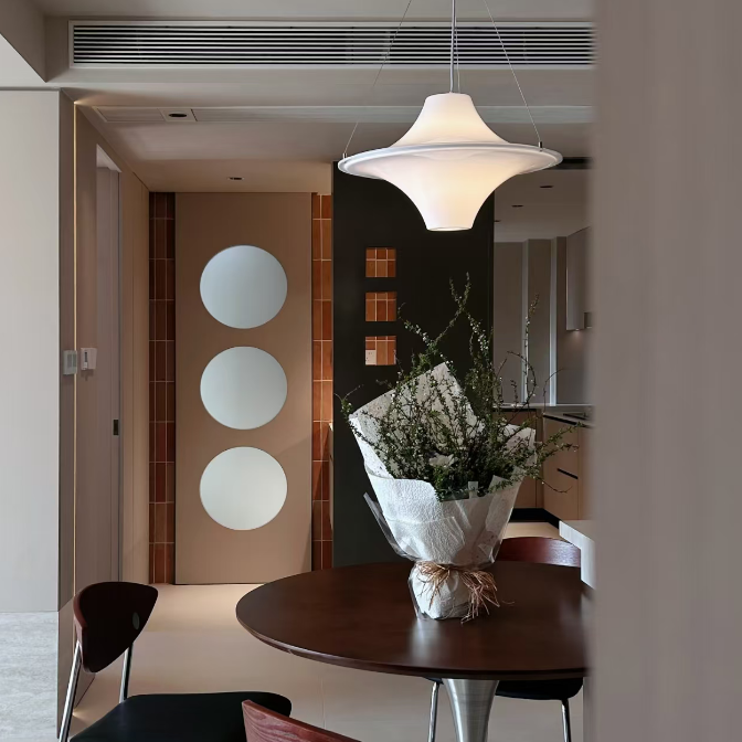 Star-shaped white disc pendant light suspended from ceiling cords