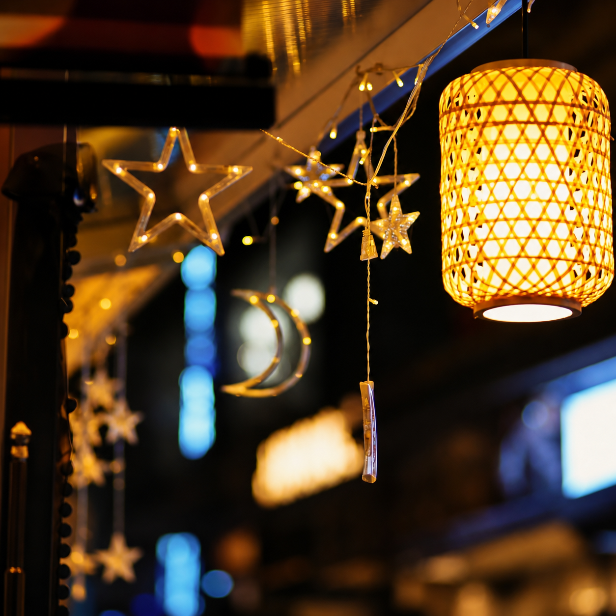 Woven golden hanging lantern with cylindrical lattice drum shade and glowing underside