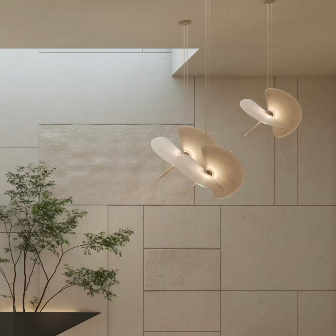 Butterfly pendant light with white dome shade and crossed blades in front of wall paneling
