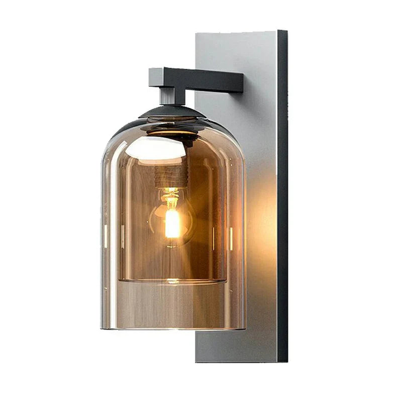 Amber tinted bell jar wall sconce with black backplate and top arm