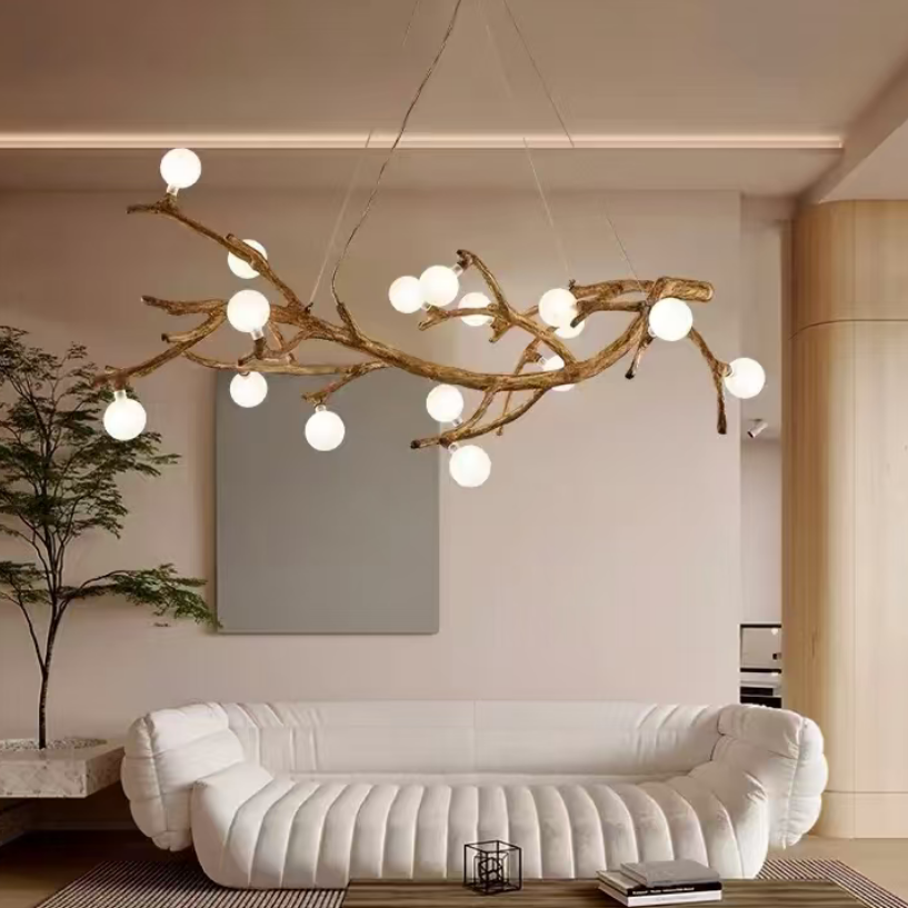 Gold branch chandelier with spherical bulbs on branching metal arms.