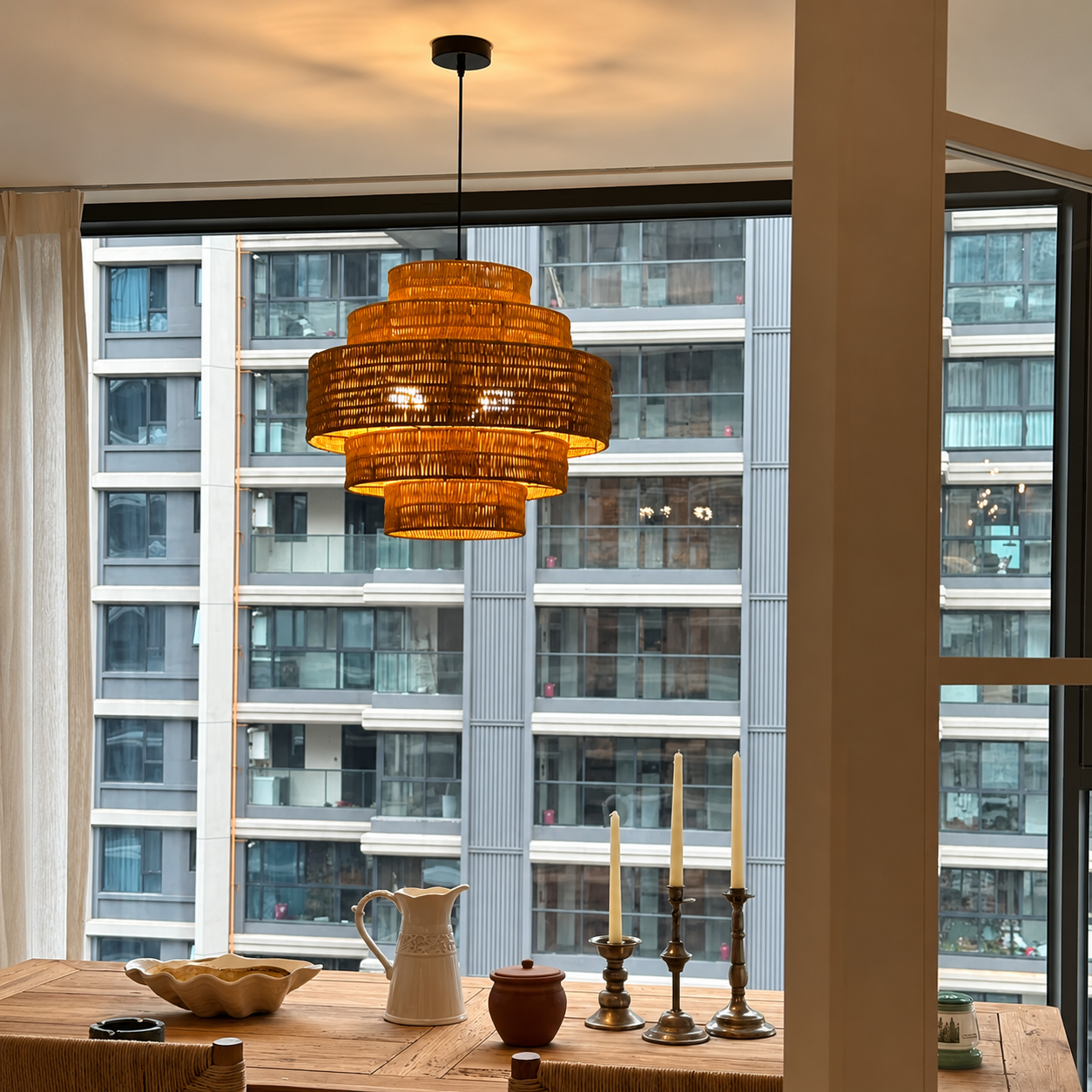 Kago rattan woven pendant light with stacked layered rattan shade and warm amber weave