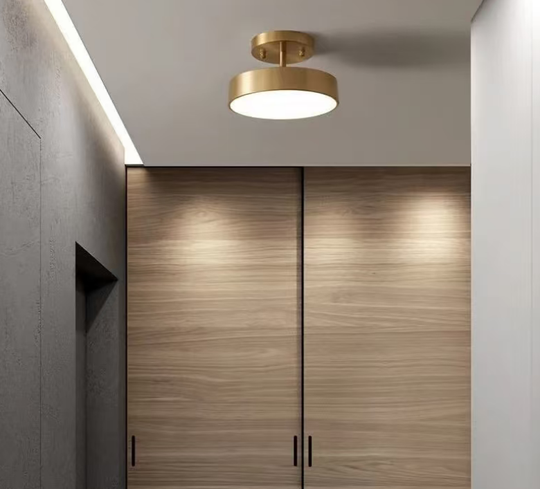 Brass drum flush mount ceiling light on a ceiling with round canopy and diffuser