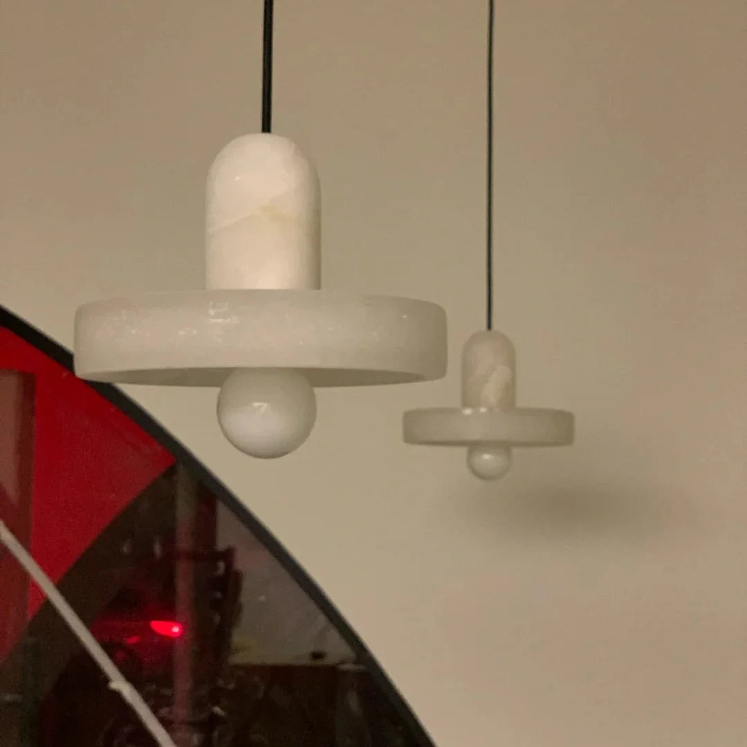 Alabaster fishline pendant light with cylindrical shade and horizontal stone crossbar