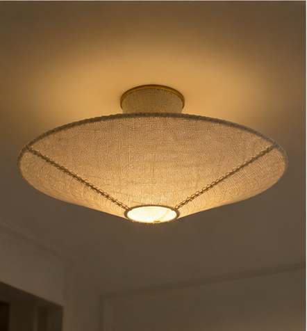 Beige woven flush mount ceiling light with lit diffuser and gold trim