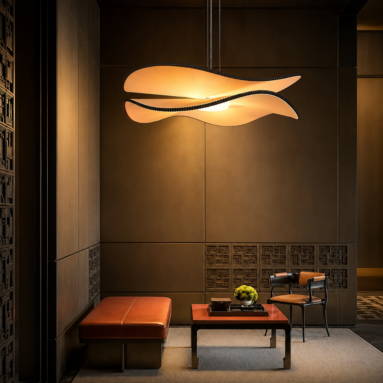 Wing-style pendant light with warm glowing curved shades suspended from the ceiling