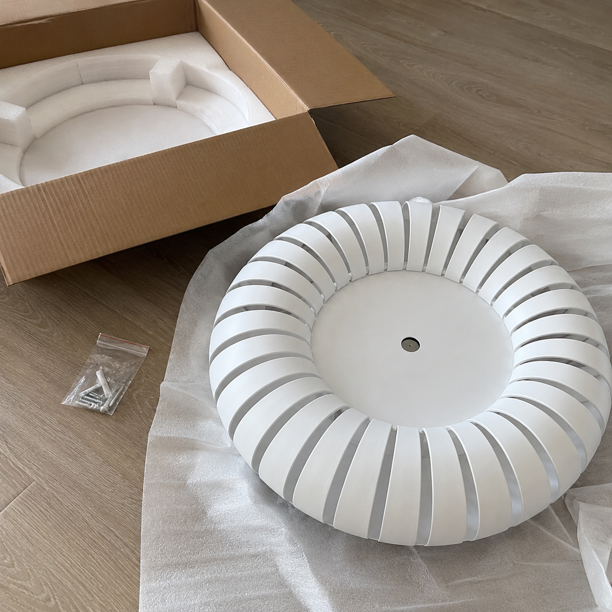 Ribbed flush mount ceiling light ring on packaging paper, white and gray design