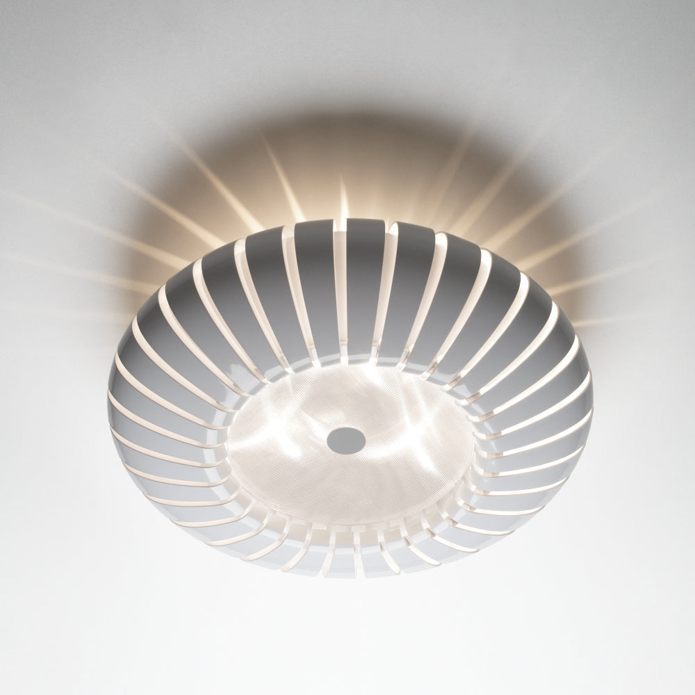 Ribbed flush mount ceiling light with white ring and central circular backplate