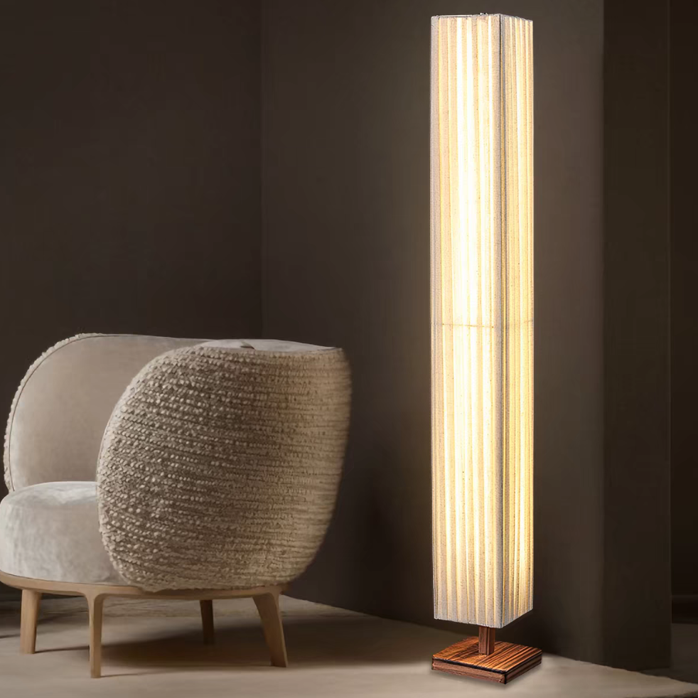 Warm-glowing off-white floor lamp with ribbed fabric shade and wood base