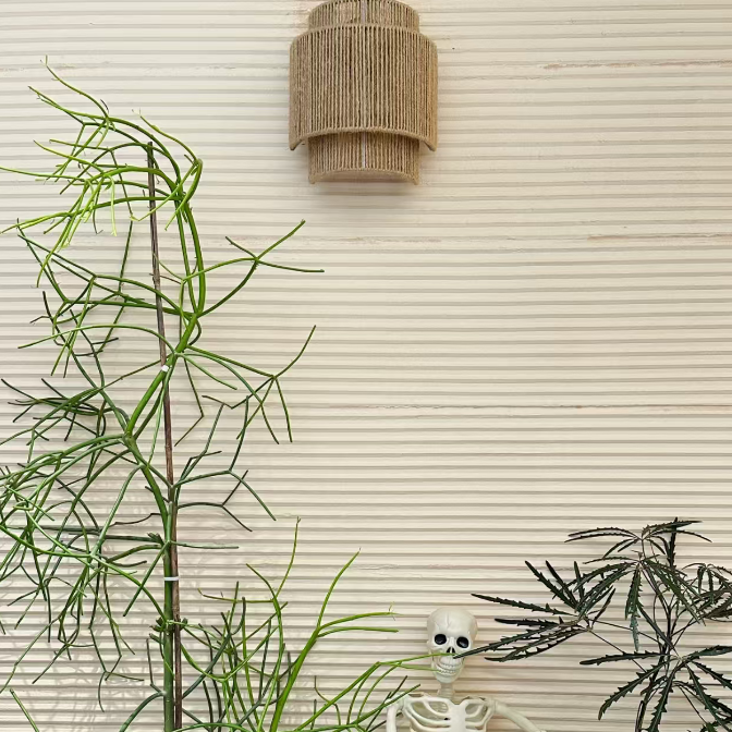 Cylindrical woven rope drum wall sconce shade in tan with ribbed vertical weave