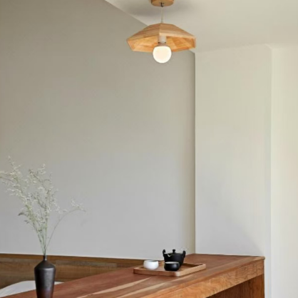 Light wood flush-mount ceiling light with small canopy and frosted bulb globe
