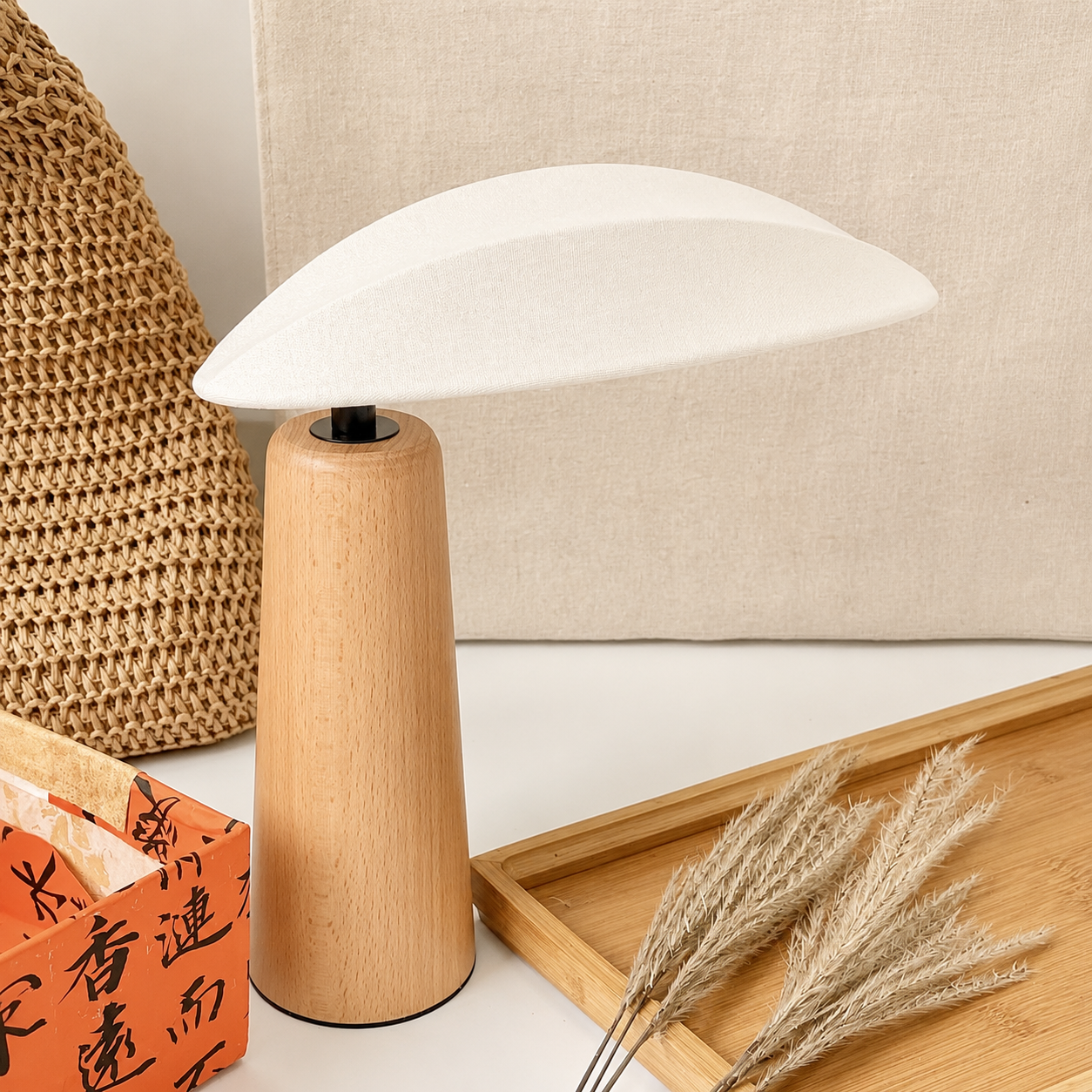 Small wood table lamp with white linen shade and tapered wooden body
