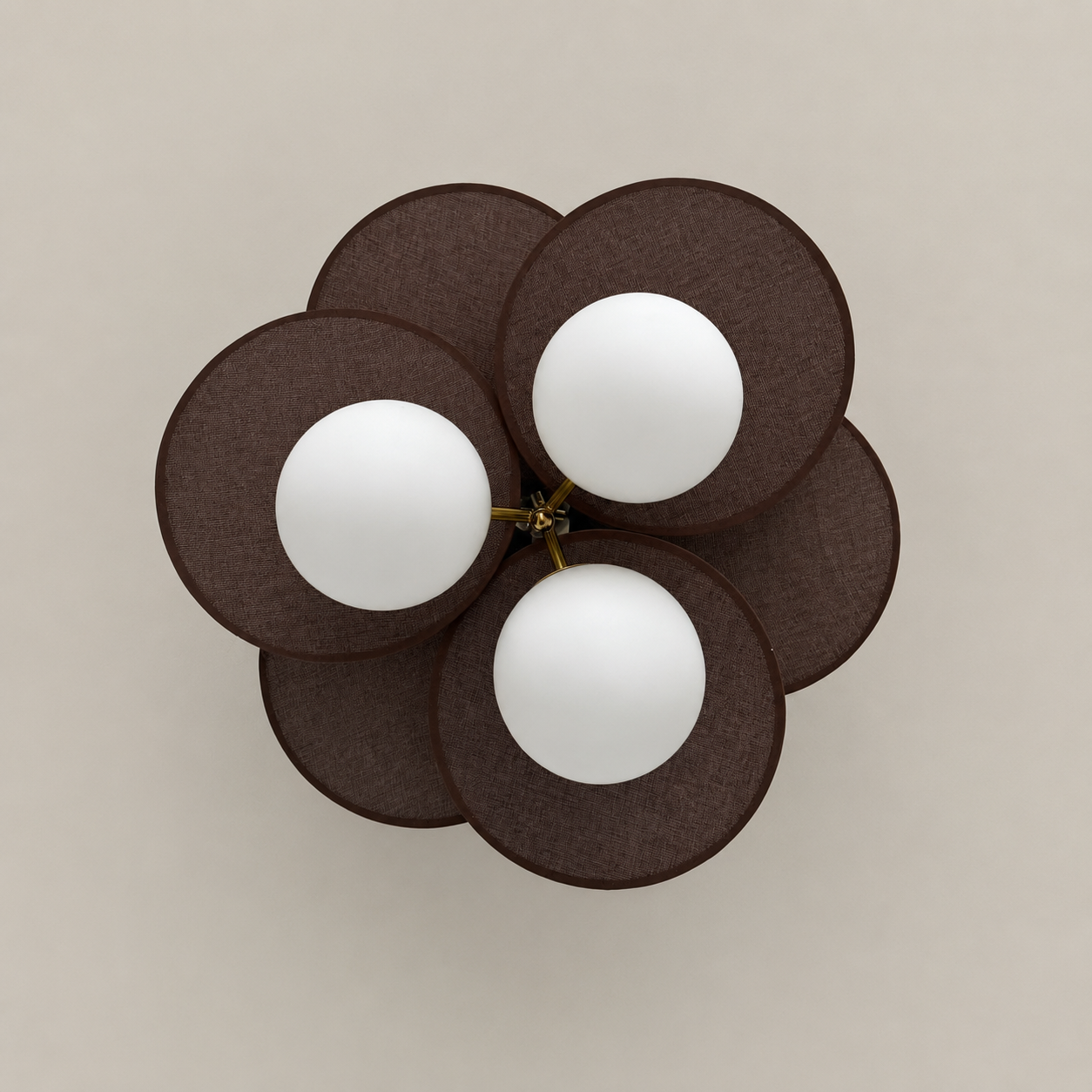 Top view of petal pendant light with dark brown fabric petals and three white globe bulbs.