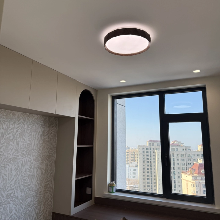 Natural wood flush mount ceiling light with warm glowing round diffuser