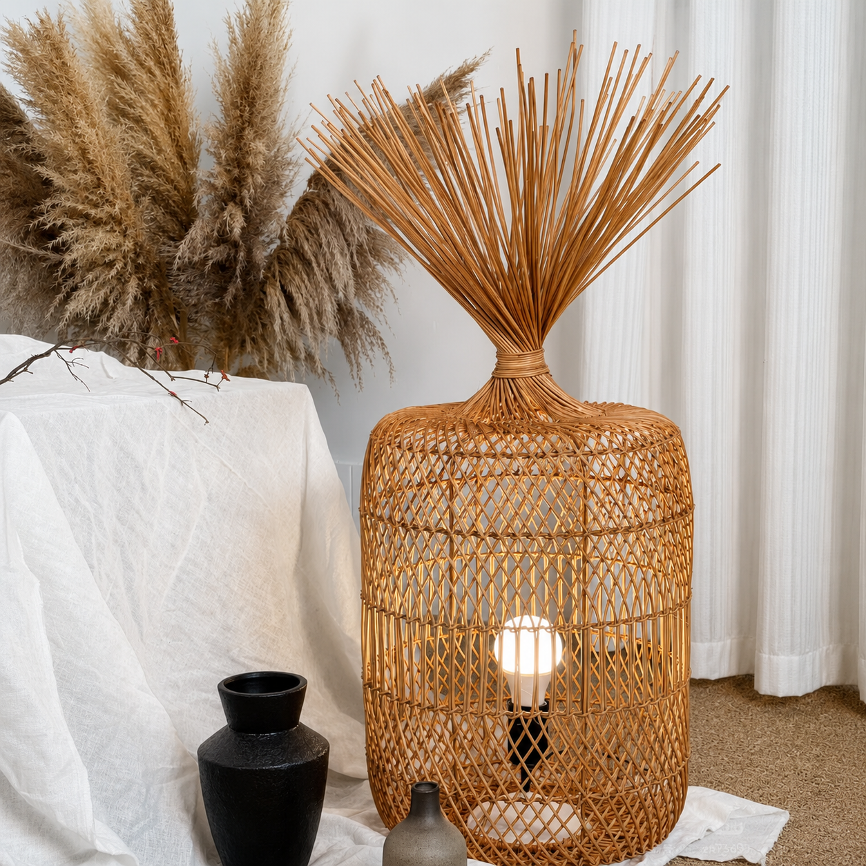 Natural rattan floor lamp with tall reed top, woven drum shade glowing beside decor