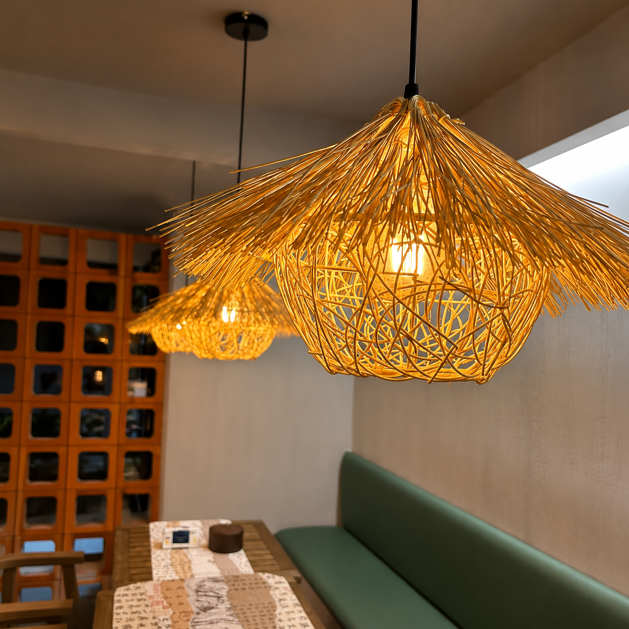 Rattan pendant light with open lattice shade, warm glow in modern room