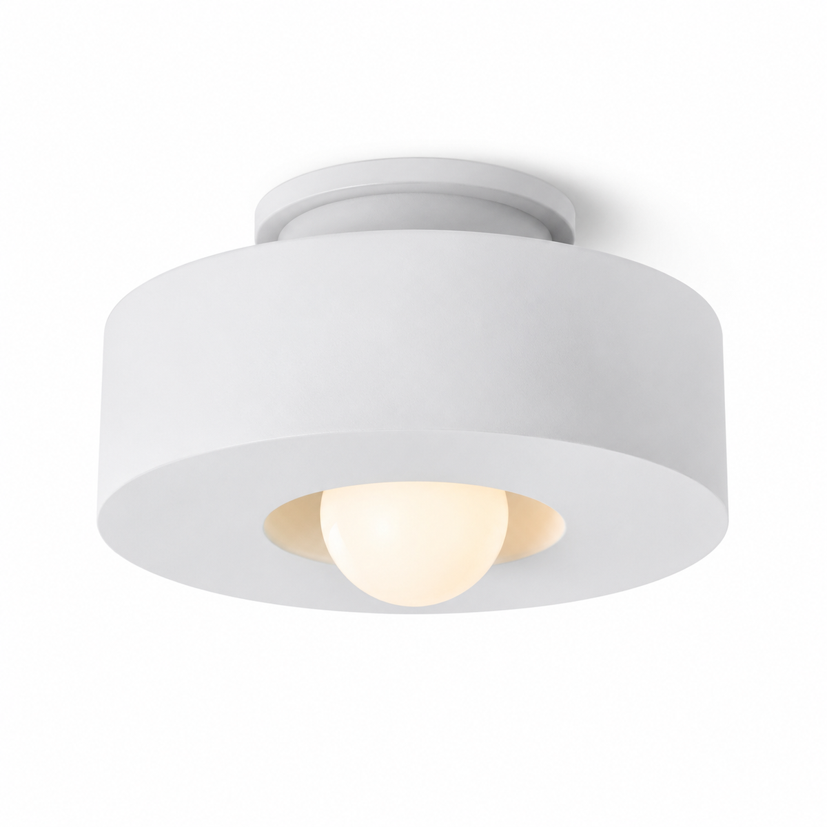White resin flush mount light with wide round shade and glowing center bulb