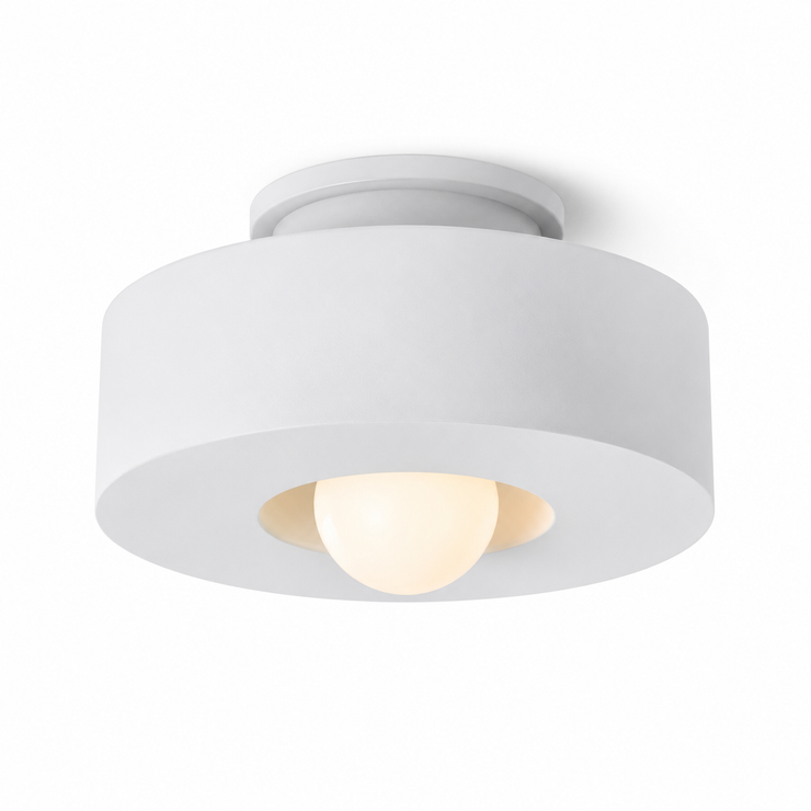 White resin flush mount light with wide round shade and glowing center bulb