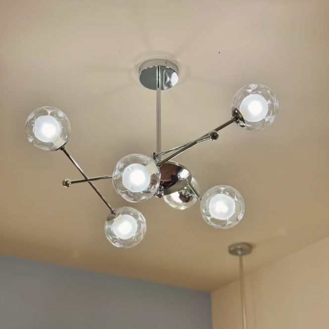 Ceiling chandelier with clear glass globe shades and chrome mounting bracket